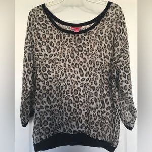 Animal print blouse with black band on sleeves, neck and waist